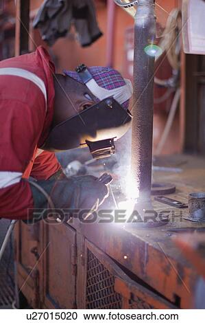 Worker welding on oil rig View Large Photo Image Stock Image - Worker welding on oil rig. Fotosearch