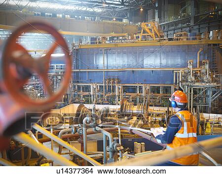 Picture - Worker with turbines in power station. Fotosearch
