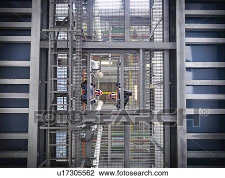 Workers at biomass storage facility View Large Photo Image Stock Image - Workers at biomass storage facility. Fotosearch