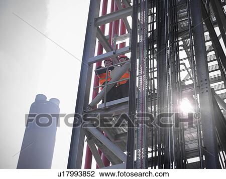 Workers at biomass storage facility View Large Photo Image Stock Image - Workers at biomass storage facility. Fotosearch