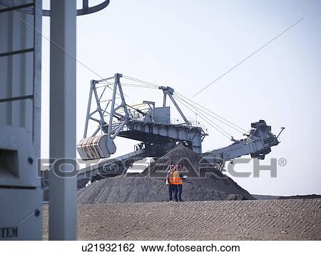 Workers at coal storage facility View Large Photo Image Stock Image - Workers at coal storage facility. Fotosearch