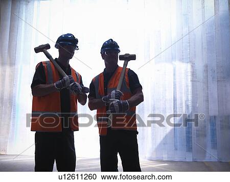 Stock Image - Workers carrying hammers. Fotosearch