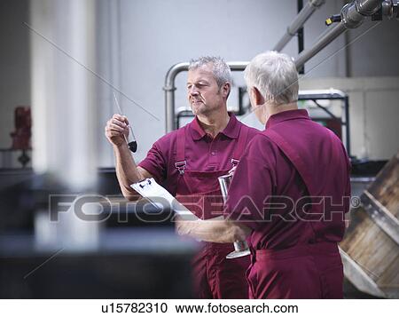 Workers checking whisky in distillery View Large Photo Image Stock Image - Workers checking whisky in distillery. Fotosearch