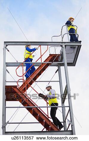 Stock Photo - Workers climbing stairs on site. Fotosearch