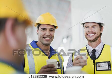 Workers having coffee together View Large Photo Image Stock Photo - Workers having coffee together. Fotosearch