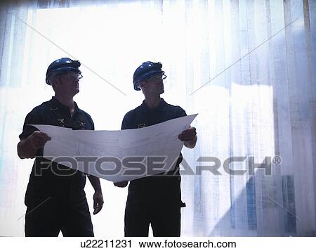 Workers holding blueprints View Large Photo Image Stock Image - Workers holding blueprints. Fotosearch