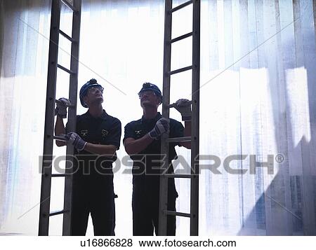 Workers holding ladders View Large Photo Image Stock Photo - Workers holding ladders. Fotosearch