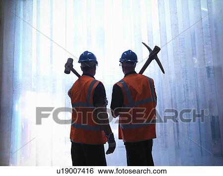 Workers holding pickax and hammer View Large Photo Image Stock Photograph - Workers holding pickax and hammer. Fotosearch