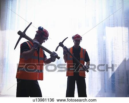 Workers holding pickaxes View Large Photo Image Stock Photograph - Workers holding pickaxes. Fotosearch