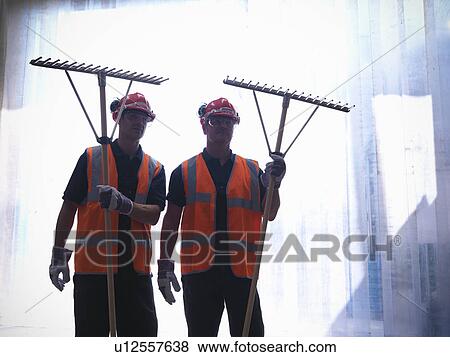 Workers holding rakes View Large Photo Image Stock Photo - Workers holding rakes. Fotosearch