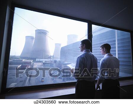 Workers looking out over power station View Large Photo Image Stock Image - Workers looking out over power station. Fotosearch