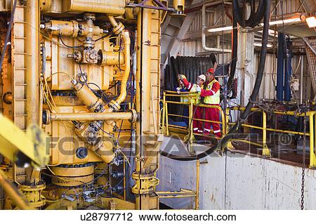 Workers on oil rig View Large Photo Image Stock Image - Workers on oil rig. Fotosearch