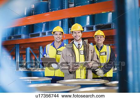 Workers standing in warehouse View Large Photo Image Picture - Workers standing in warehouse. Fotosearch