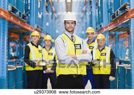 Workers standing in warehouse View Large Photo Image Stock Photo - Workers standing in warehouse. Fotosearch