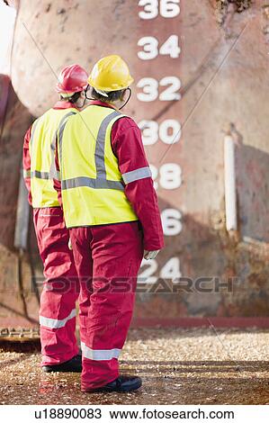 Workers standing on oil rig View Large Photo Image Stock Image - Workers standing on oil rig. Fotosearch