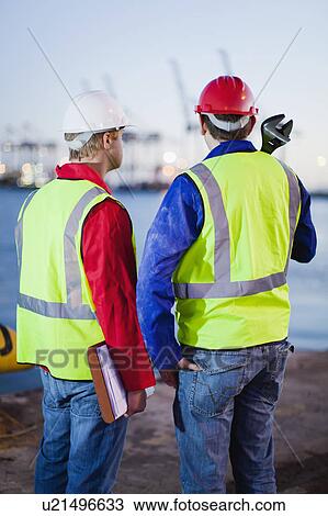 Workers standing together in shipyard View Large Photo Image Stock Image - Workers standing together in shipyard. Fotosearch