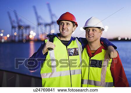 Workers standing together in shipyard View Large Photo Image Stock Image - Workers standing together in shipyard. Fotosearch