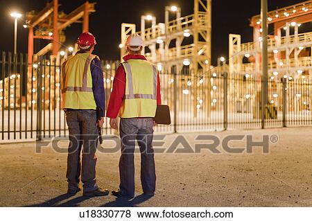 Workers standing together in shipyard View Large Photo Image Stock Photo - Workers standing together in shipyard. Fotosearch
