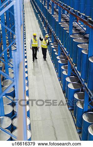 Workers talking in warehouse View Large Photo Image Stock Photo - Workers talking in warehouse. Fotosearch