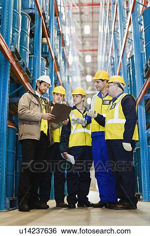 Workers talking in warehouse View Large Photo Image Stock Photograph - Workers talking in warehouse. Fotosearch