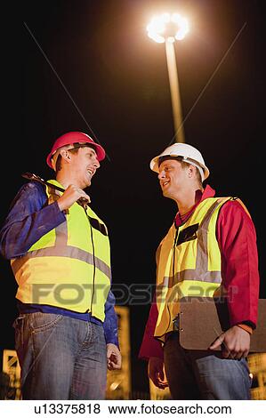 Workers talking on construction site View Large Photo Image Stock Photo - Workers talking on construction site. Fotosearch
