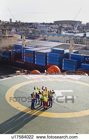 Workers talking on helipad of oil rig View Large Photo Image Stock Image - Workers talking on helipad of oil rig. Fotosearch