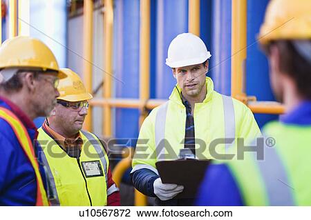 Workers talking on oil rig View Large Photo Image Stock Image - Workers talking on oil rig. Fotosearch