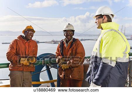 Workers talking on oil rig View Large Photo Image Stock Photo - Workers talking on oil rig. Fotosearch