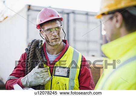 Workers talking on oil rig View Large Photo Image Stock Photography - Workers talking on oil rig. Fotosearch