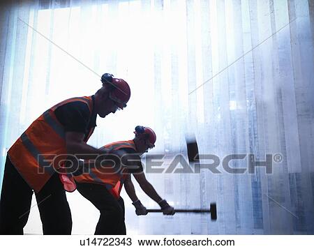 Workers using hammers together View Large Photo Image Stock Image - Workers using hammers together. Fotosearch