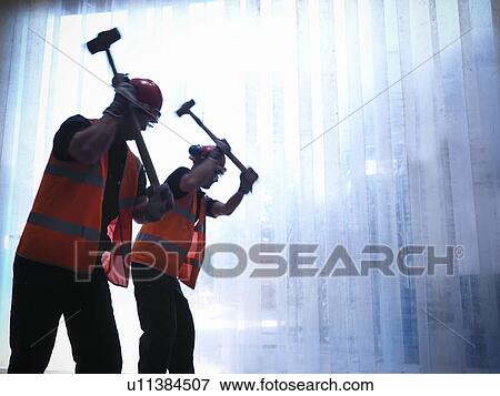 Workers using hammers together View Large Photo Image Stock Photo - Workers using hammers together. Fotosearch