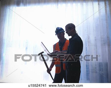 Workers using laptop together View Large Photo Image Stock Image - Workers using laptop together. Fotosearch