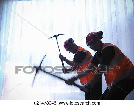 Stock Photograph - Workers using pickaxes together. Fotosearch