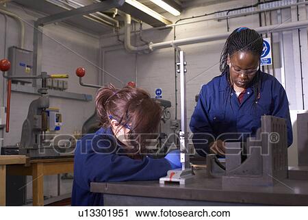 Workers using tools in factory View Large Photo Image Stock Image - Workers using tools in factory. Fotosearch