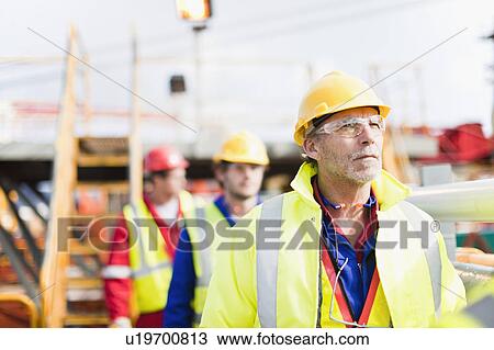 Workers walking on oil rig View Large Photo Image Stock Image - Workers walking on oil rig. Fotosearch