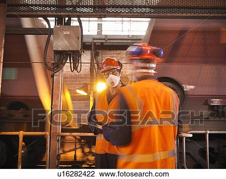 Workers wearing face mask in facility View Large Photo Image Stock Image - Workers wearing face mask in facility. Fotosearch