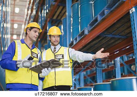Stock Photo - Workers with containers in warehouse. Fotosearch