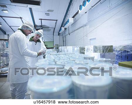 Workers with yogurt in dairy cold store View Large Photo Image Stock Photo - Workers with yogurt in dairy cold store. Fotosearch