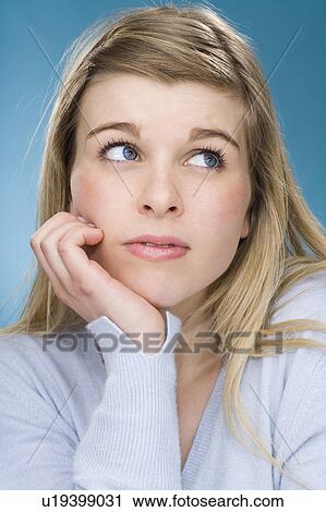 Worried girl resting chin in hand View Large Photo Image Stock Image - Worried girl resting chin in hand. Fotosearch