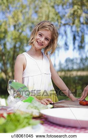 Young girl making picnic lunch View Large Photo Image Stock Photography - Young girl making picnic lunch. Fotosearch