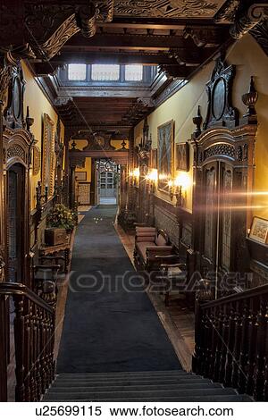 Stock Photography - Casa Aliaga interior, corridor with ornate mahogany doorways and ceilings, Spanish tile work and paintings from Spanish Baroque era, Lima, Peru. Fotosearch