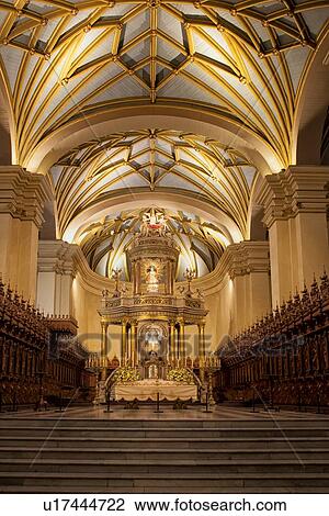 Stock Image - Catedral of Lima: gilded altar seen from front, with graceful gilded ribbed arched ceiling, wooden rococo choir stalls Spanish Baroque, Lima, Peru. Fotosearch