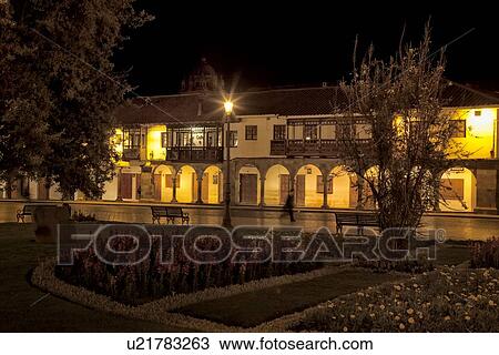 Stock Image - Cuzco by night: stone arcade lined with stone arches and ornate wooden balconies typical of Spanish Colonial style, Cuzco, Peru. Fotosearch