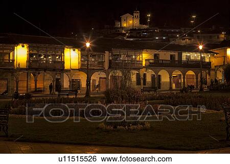 Cuzco by night: stone arcade lined with stone arches and ornate wooden balconies typical of Spanish Colonial style, Cuzco, Peru View Large Photo Image Stock Photograph - Cuzco by night: stone arcade lined with stone arches and ornate wooden balconies typical of Spanish Colonial style, Cuzco, Peru. Fotosearch