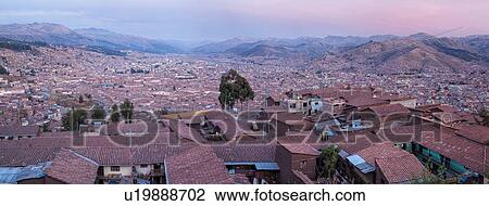 Cuzco city at sunset: panorama view of rooftops and mountains of Sacred Valley beyond, Sacred Valley, Cuzco, Peru View Large Photo Image Stock Image - Cuzco city at sunset: panorama view of rooftops and mountains of Sacred Valley beyond, Sacred Valley, Cuzco, Peru. Fotosearch