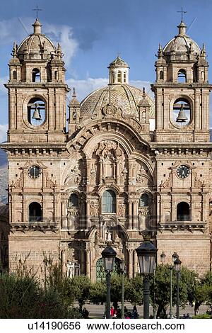 Stock Photograph - Cuzco: Plaza de Armas, view of Iglesia de la Compania, after afternoon rain shower, blue sky with clouds, Cuzco, Sacred Valley, Peru. Fotosearch
