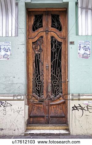 Door: close up of Spanish colonial wooden door with ornate bronze decoration, pastel green walls with graffiti, Lima, Peru View Large Photo Image Stock Image - Door: close up of Spanish colonial wooden door with ornate bronze decoration, pastel green walls with graffiti, Lima, Peru. Fotosearch