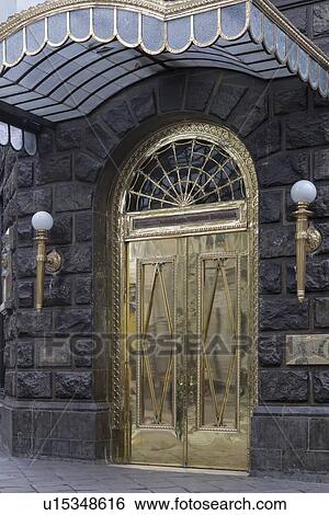 Doorway with brass double doors and awning in Art Nouveau style with granite brickwork, reflections of street, Lima, Peru View Large Photo Image Stock Photograph - Doorway with brass double doors and awning in Art Nouveau style with granite brickwork, reflections of street, Lima, Peru. Fotosearch