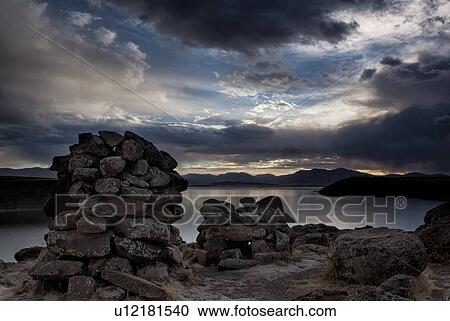 Lake Titicaca: Sillustani funerary towers with view across Lake Umaya at sunset, dramatic storm clouds and light, Peru View Large Photo Image Stock Image - Lake Titicaca: Sillustani funerary towers with view across Lake Umaya at sunset, dramatic storm clouds and light, Peru. Fotosearch