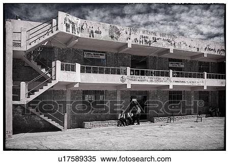 Lake Titicaca: Taquile island central plaza pink stucco and brick building with stairs to balcony and roof, graffiti, men in traditional costume grouped outside, desaturated image, Peru View Large Photo Image Stock Photography - Lake Titicaca: Taquile island central plaza pink stucco and brick building with stairs to balcony and roof, graffiti, men in traditional costume grouped outside, desaturated image, Peru. Fotosearch